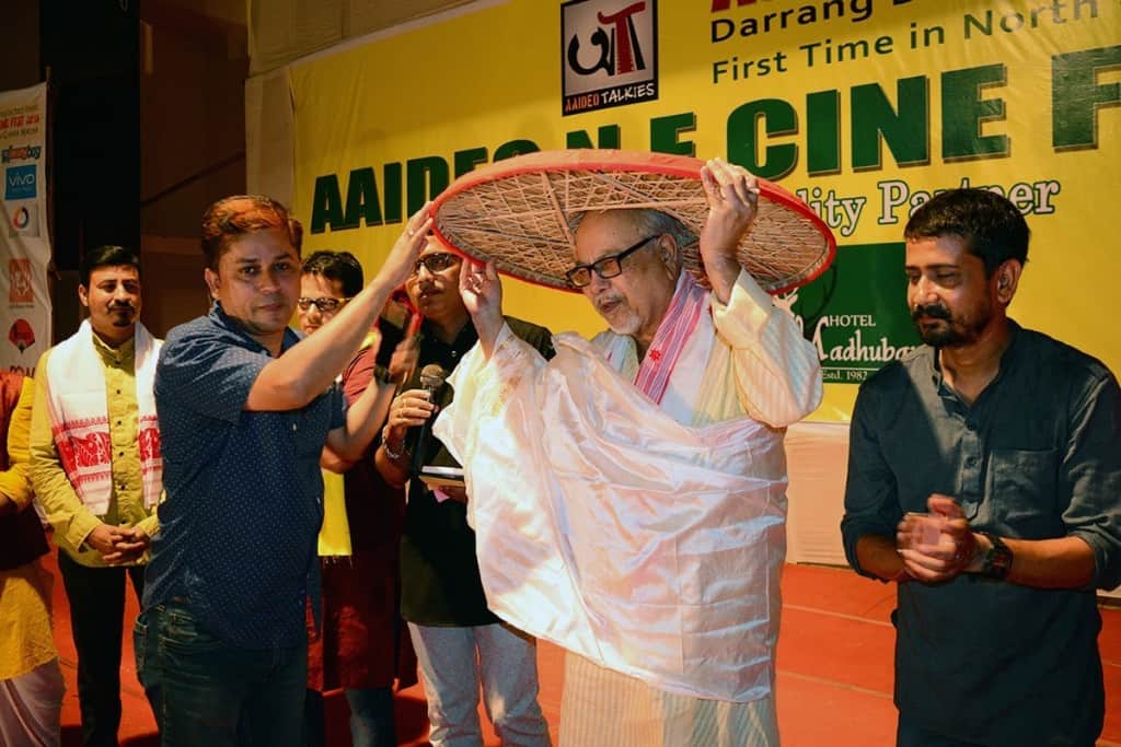 Eminent playwright director actor lyricist Hemanta Dutta is seen offering a japi by one of the organizer in presence of other organizers – The News Mill
