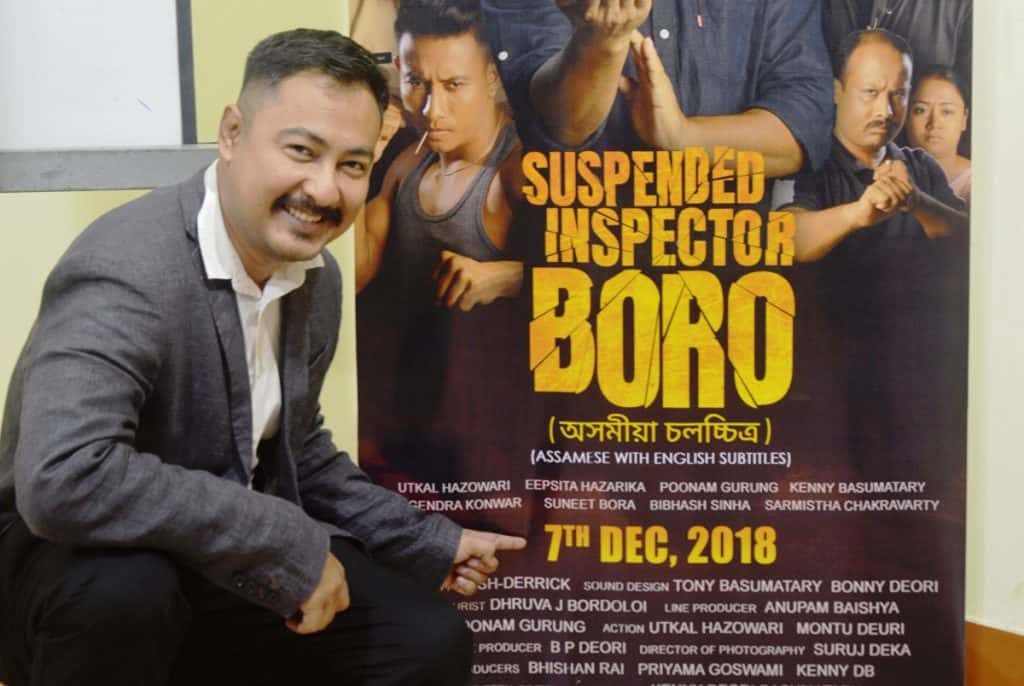 Kenny Basumatary poses with the poster of Suspended Inspector Boro at the films trailer launch 3 – The News Mill