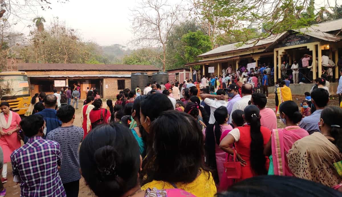 People queue up for voting at a polling station in Guwahati West constituency in Assam on April 6
