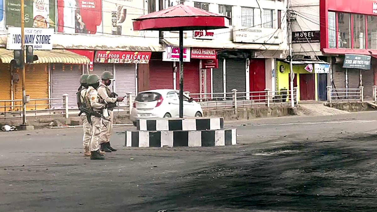 Security personnel stand guard after violent clashes in Manipur